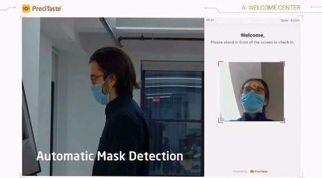 AI Welcome Center automatically turns on when a person faces it. Then it performs a quick temperature measure with laser-sensing technology and checks for face masks using "vision AI."
